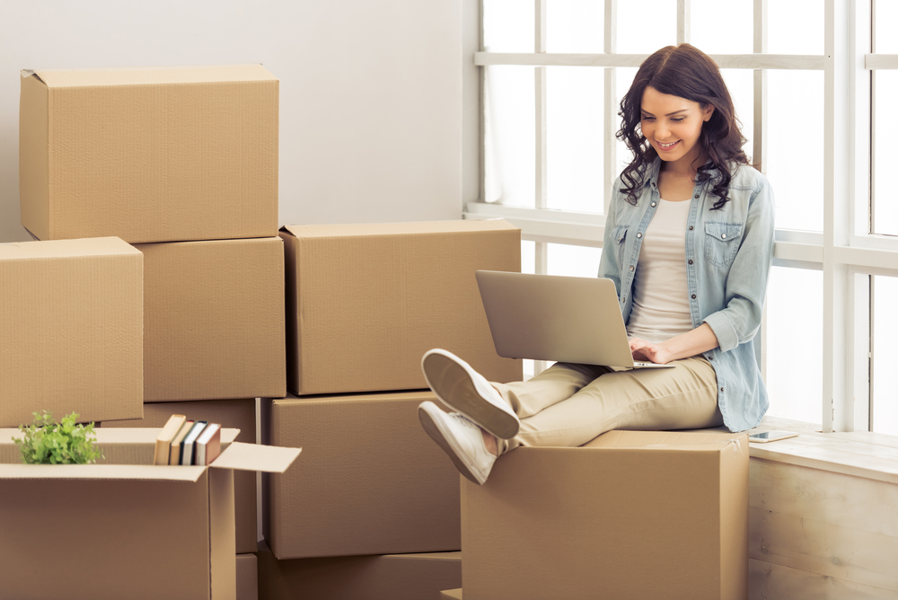 Young adult women moving boxes