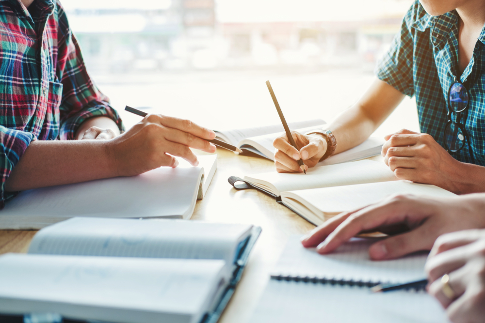 Students studying with pens and paper